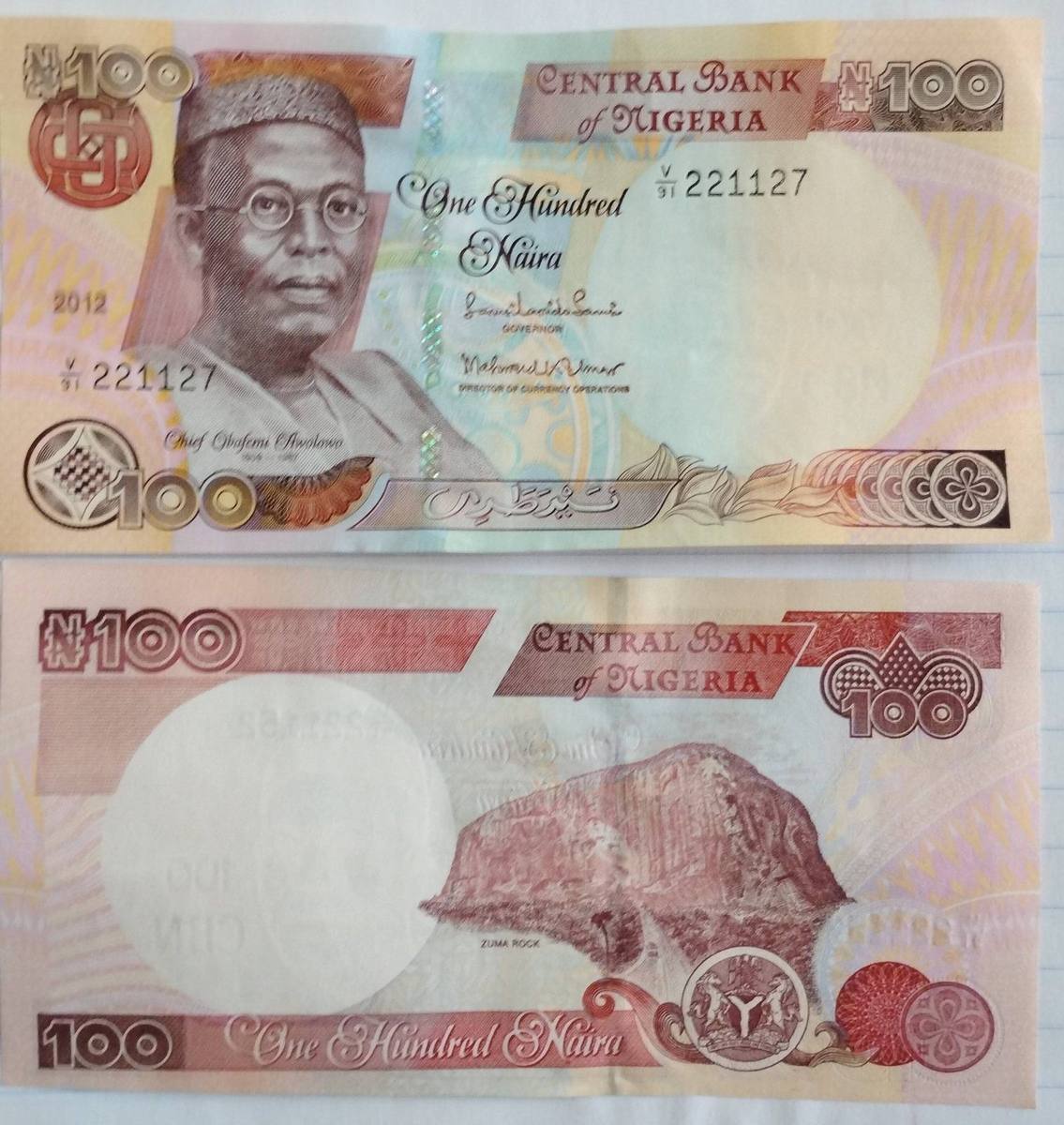 One hundred naira note bearing Chief Obafemi Awolowo, front and back, the back showing Zuma Rock